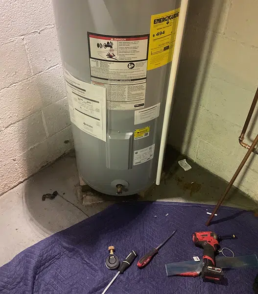 Water heater maintenance with floor drop cloth in Freedom, PA